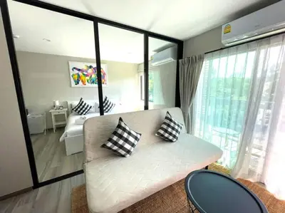 a living room with a white couch with pillows on it at B5 НОВАЯ вид БАССЕЙН ВАТСАП669З582I976 in Phuket Town