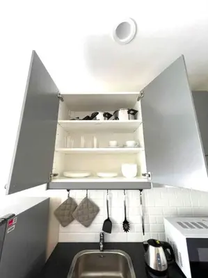 a kitchen with a sink and a shelf with utensils at B5 НОВАЯ вид БАССЕЙН ВАТСАП669З582I976 in Phuket Town
