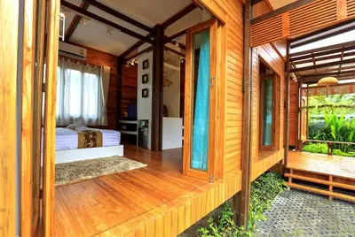 a wooden room with a bed on a wooden deck at Viangviman Luxury Resort, Krabi in Ao Nang Beach