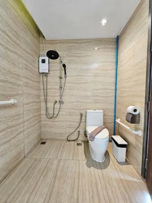 a bathroom with a shower and a toilet in a room at Duplex Pool Access 2brs Patong in Patong Beach