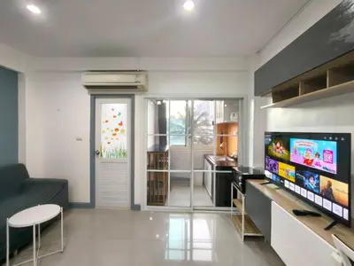 a living room with a tv and a couch at Cozy Patong studio apartment in Patong Beach