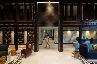 a woman walks through a shopping mall with a woman walking in the background at The base central phuket in Phuket Town