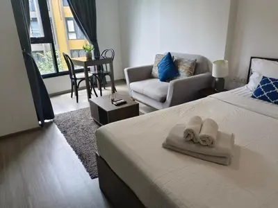 a hotel room with a bed and a living room at The base central phuket in Phuket Town