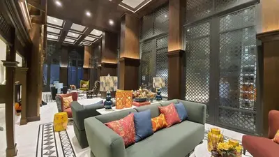 a living room with a couch with colorful pillows at The base central phuket in Phuket Town