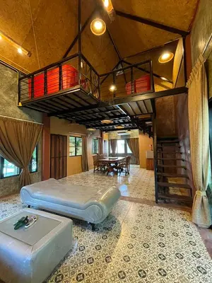 a large room with a bed and a loft at Baibon1 Boutique House Thalang Phuket in Ban Na Nai