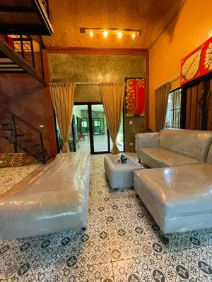 a living room with two beds and a couch at Baibon1 Boutique House Thalang Phuket in Ban Na Nai