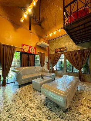 a large living room with two beds and a couch at Baibon1 Boutique House Thalang Phuket in Ban Na Nai