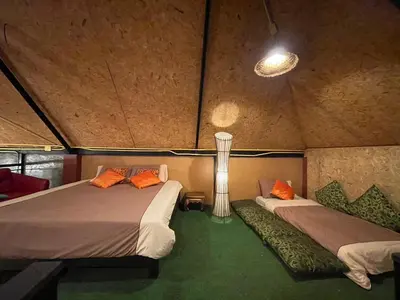 a room with two beds in a tent at Baibon1 Boutique House Thalang Phuket in Ban Na Nai