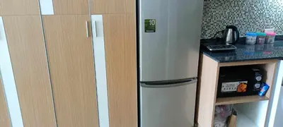 a kitchen with a refrigerator next to a counter at Naithon Beachfront Condotel in Nai Thon Beach