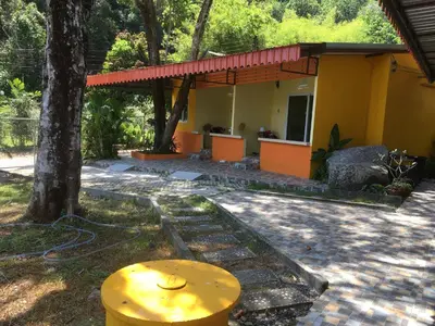 a yellow house with a tree in front of it at Kathu Waterfall Bungalow Holyday home in Ban Huai Luk (1)