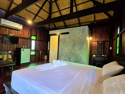 a bedroom with a large bed with white sheets at Baan Koh Kwang Pool Villa Krabi in Krabi town
