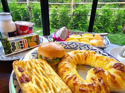 a plate of food with a sandwich and a pretzel at Baan Koh Kwang Pool Villa Krabi in Krabi town