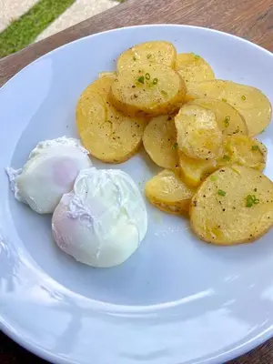 a plate of food with potato chips and a dumpling at Kata Hillside Hideaway in Kata Beach