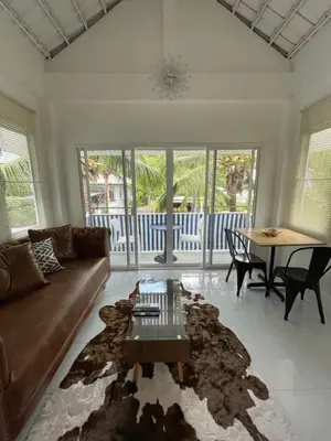 a living room with a couch and a table at Kata Hillside Hideaway in Kata Beach