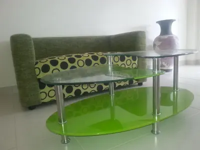 two glass tables in front of a couch at The Green House in Kata Beach