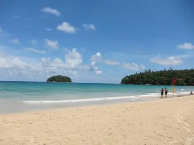 two people walking on the beach with a kite at The Green House in Kata Beach