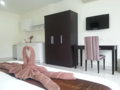 a pink dress is on the floor in a room at The Green House in Kata Beach