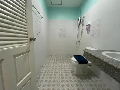 a bathroom with a toilet and a sink at NUN GUEST HOUSE in Ban Bo Han