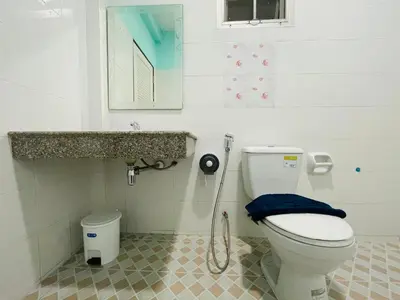 a bathroom with a toilet and a sink at NUN GUEST HOUSE in Ban Bo Han