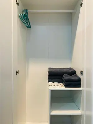 a walkin closet with towels on a shelf at NUN GUEST HOUSE in Ban Bo Han