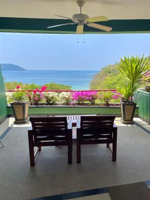 two benches in a room with a view of the ocean at Kata Sea View Sanctuary in Kata Beach