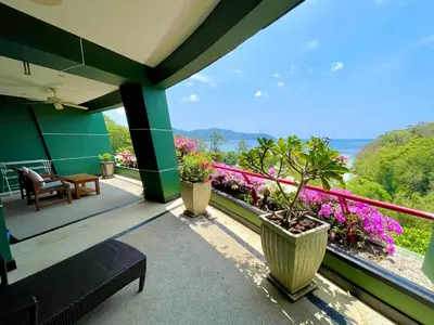 a balcony with potted plants on a house at Kata Sea View Sanctuary in Kata Beach