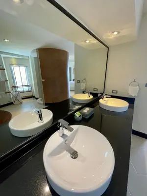 a bathroom with two sinks and a large mirror at Kata Sea View Sanctuary in Kata Beach