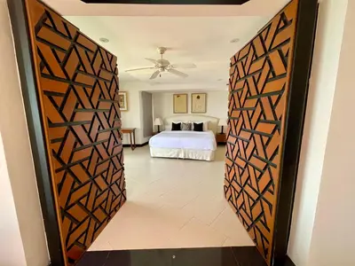 a hotel room with a bed and a bedroom at Kata Sea View Sanctuary in Kata Beach