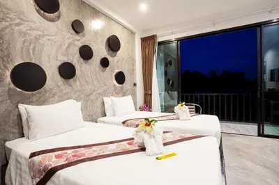 a hotel room with two beds and a balcony at Aonang Viva Resort - SHA Plus in Ao Nang Beach