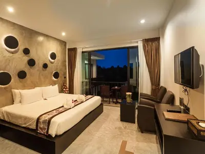 a bedroom with a bed and a desk and a television at Aonang Viva Resort - SHA Plus in Ao Nang Beach