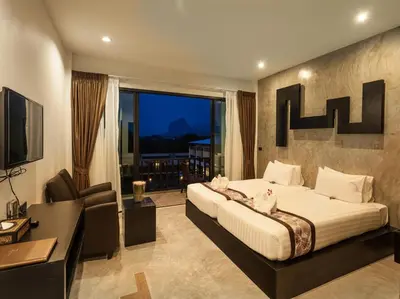 a bedroom with a bed and a desk and a television at Aonang Viva Resort - SHA Plus in Ao Nang Beach