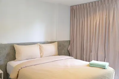 a bedroom with a bed and a window at Y House Patong in Patong Beach