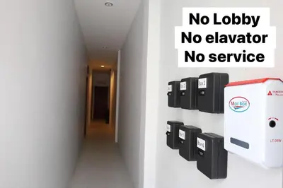 a no lobby no elevator no service sign on a wall at Y House Patong in Patong Beach