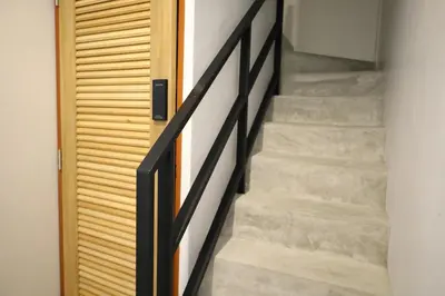 a stairway leading up to a wooden door at Y House Patong in Patong Beach