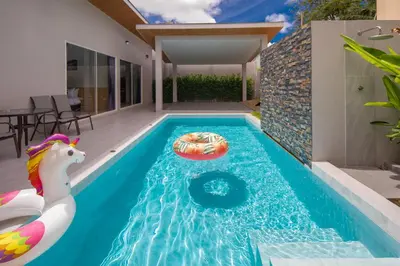 a swimming pool with a pool noodle in a house at Sasi Pool Villa Phuket in Rawai Beach
