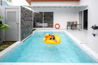 a woman in a yellow raft in a swimming pool at Sasi Pool Villa Phuket in Rawai Beach