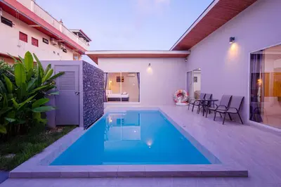 a swimming pool in the backyard of a house at Sasi Pool Villa Phuket in Rawai Beach