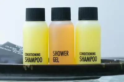three bottles of shampoo and conditioner on a shelf at Sasi Pool Villa Phuket in Rawai Beach