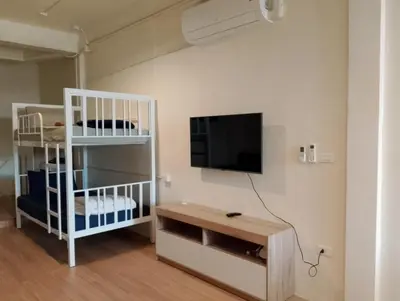 a room with a bed and a tv on a wall at Bonanza Patong Beach1 100m to Beach Star Room in Patong Beach