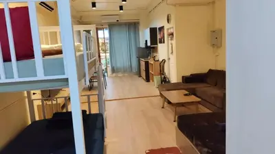 a living room with a couch and a table at Bonanza Patong Beach1 100m to Beach Star Room in Patong Beach