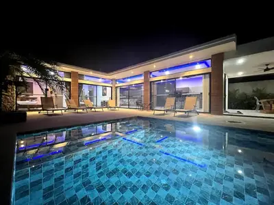 a swimming pool in a house at night at Villa Christal - Modern 3 bedrooms with pool in Ban Saiyuan (1)