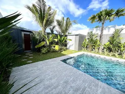 a swimming pool in front of a house with palm trees at Villa Christal - Modern 3 bedrooms with pool in Ban Saiyuan (1)