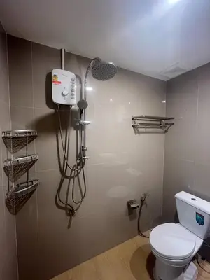 a bathroom with a toilet and a shower at MYP Cherngtalay in Phuket Town
