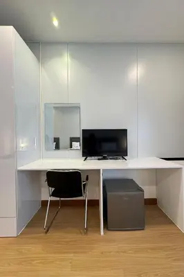 a white desk with a computer and a chair at MYP Cherngtalay in Phuket Town