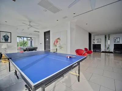 a large room with a ping pong table in it at Villa Amonteera in Surin Beach