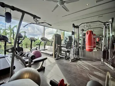 a gym with a bunch of equipment in it at Villa Amonteera in Surin Beach