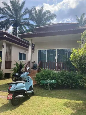 a scooter parked in front of a house at Lay Back Villa C2 with Kitchen & High speed Internet in Krabi town