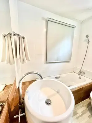 a white bathroom with a sink and a tub at Lay Back Villa C2 with Kitchen & High speed Internet in Krabi town