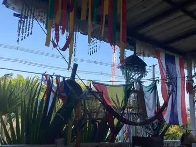 a bunch of colorful flags hanging from a building at Lay Back Villa C2 with Kitchen & High speed Internet in Krabi town