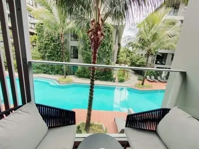 a view of a swimming pool from a balcony at 1 Bedroom Pool view at Diamond Condo, Bangtao in Bang Tao Beach